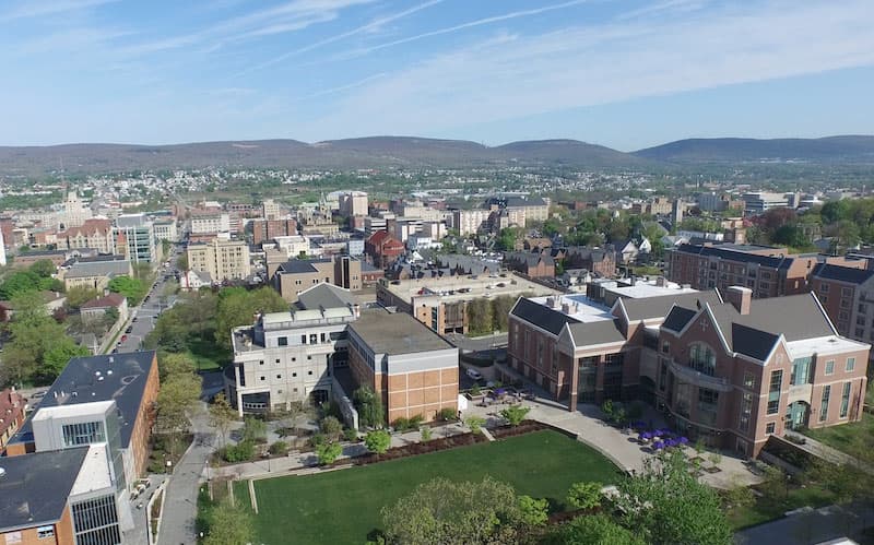 Drone shot high above campus highlighting the Dionne Green, DeNaples Student Center and the Weinberg Memorial Library